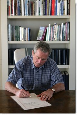 President George W. Bush signs into law H.R. 3010, the "Departments of Labor, Health and Human Services, and Education, and Related Agencies Appropriations Act, 2006" from the Bush ranch Friday, Dec. 30, 2005, in Crawford, Texas.  White House photo by Shealah Craighead