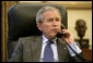 President George W. Bush and West Virginia Governor Joe Manchin discuss the rescue efforts to save miners trapped in a Tallmansville, W. Va. mine, during a phone call from the Oval Office Tuesday, Jan. 3, 2006. White House photo by Eric Draper
