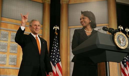 President George W. Bush returns the "Hook'em Horns" hand gesture back to audience members, Thursday, Jan. 5, 2006, as he is being introduced by U.S. Secretary of State Condoleezza Rice at the State Department, prior to his remarks to the U.S. University Presidents Summit on International Education. The gesture was in recognition of the University of Texas football team's victory over the University of Southern California in the Rose Bowl, Wednesday evening. White House photo by Kimberlee Hewitt