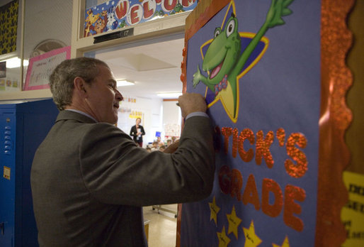 President George W. Bush signs a classroom door during his visit with teachers and students at North Glen Elementary School in Glen Burnie, Md., Monday, Jan. 9, 2006. White House photo by Kimberlee Hewitt