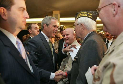 After talking about progress in the War on Terror with members of the Veterans of Foreign War, President George W. Bush greets audience members in Washington, D.C., Jan. 10, 2006. "This is one of America's great organizations. I appreciate the proud and patriotic work you do across America," said the President. White House photo by Paul Morse