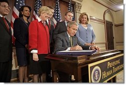President George W. Bush signs H.R. 972, the Trafficking Victims Protection Reauthorization Act of 2005, in the Dwight D. Eisenhower Executive Office Building Tuesday, Jan. 10, 2006. The bill directs the U.S. Agency for International Development (USAID), the State Dept., and Dept. of Defense to incorporate anti-trafficking and protection measures for vulnerable populations, particularly women and children, into their post-conflict and humanitarian emergency assistance and program activities.  White House photo by Eric Draper