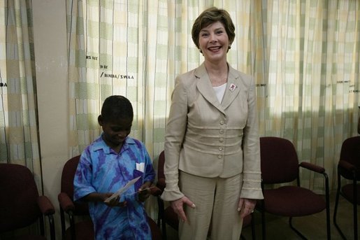 Mrs. Laura Bush stands with a young boy as she visits with patients, their family members and staff at the Korle-Bu Treatment Center, Tuesday, Jan. 17, 2006 in Accra, Ghana. White House photo by Shealah Craighead