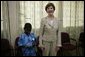 Mrs. Laura Bush stands with a young boy as she visits with patients, their family members and staff at the Korle-Bu Treatment Center, Tuesday, Jan. 17, 2006 in Accra, Ghana. White House photo by Shealah Craighead