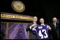 President George W. Bush receives a Kansas State Football jersey from University President Jon Wefald, center, with Kansas Senator Pat Roberts before delivering remarks on the global War on Terror at Kansas State University in Manhattan, Kan., Monday, Jan. 23, 2006. White House photo by Eric Draper