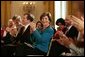 Laura Bush applauds The Moving in the Spirit dancers performance Wednesday, Jan. 25, 2006 in the East Room of the White House, during the President's Committee on the Arts and the Humanities 2006 Coming Up Taller Awards ceremony. White House photo by Paul Morse