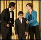 Laura Bush congratulates Jose Fernando Salas, left, and Carlos Gabriel Pascual from the Art and Children Program of Veracruz, Mexico, at their award presentation Wednesday, Jan. 25, 2006 in the East Room of the White House, during the President's Committee on the Arts and the Humanities 2006 Coming Up Taller Awards ceremony. White House photo by Shealah Craighead