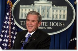 President George W. Bush smiles as he listens to reporter's question Thursday, Jan. 26, 2006, during a press conference at the White House that covered several topics including economy, the upcoming election year and fiscal policy.  White House photo by Kimberlee Hewitt