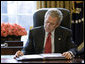 President George W. Bush reads over a draft of his State of the Union speech in the Oval Office Tuesday morning, Jan. 31, 2006, in preparation for the annual address to the nation scheduled for this evening. White House photo by Eric Draper