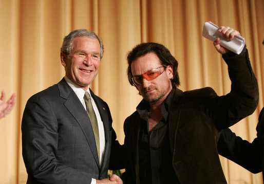 President George W. Bush shakes hands with Bono after the musician spoke Thursday morning, Feb. 2, 2006, during the National Prayer Breakfast. President Bush called the rock star a "doer" and a "good citizen of the world." White House photo by Paul Morse