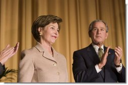 Mrs. Laura Bush acknowledges applause from President George W. Bush and the audience Thursday, Feb. 2, 2006, as she's introduced during the National Prayer Breakfast at the Hilton Washington Hotel.  White House photo by Paul Morse