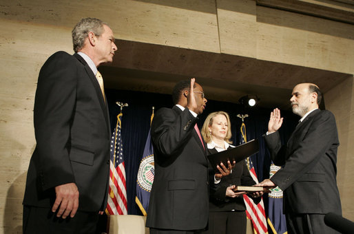 President George W. Bush participates in the swearing-in ceremony Monday, Feb. 6, 2006, for Ben Bernanke as Chairman of the Federal Reserve. Vice Chairman Roger W. Ferguson, Jr., administers the oath of office to Chairman as Mrs. Anna Bernanke, the Chairman's wife, holds the Bible. White House photo by Kimberlee Hewitt