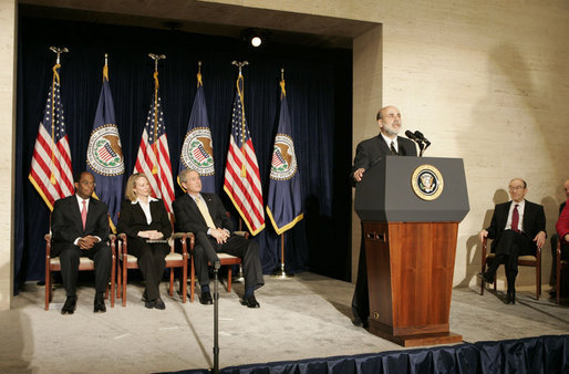 With his predecessor, Alan Greenspan, looking on, Chairman Ben Bernanke addresses President George W. Bush and others after being sworn in to the Federal Reserve post. Also on stage with the President are Mrs. Anna Bernanke and Roger W. Ferguson, Jr., Vice Chairman of the Federal Reserve. White House photo by Kimberlee Hewitt