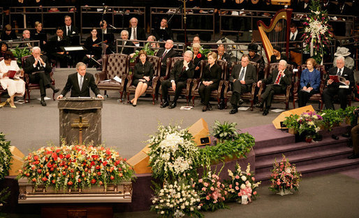 President George W. Bush addresses guests at the homegoing celebration for Coretta Scott King, Tuesday, Feb. 7, 2006 at the New Birth Missionary Church in Atlanta, Ga. In the background-right are Mrs. Laura Bush, former President Bill Clinton, U.S. Sen. Hillary Clinton, former President George H. W. Bush, former President Jimmy Carter, Mrs. Roslyn Carter and U.S. Sen. Edward M. Kennedy. White House photo by Eric Draper