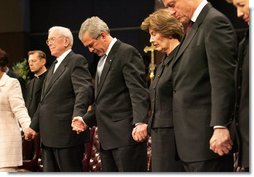 President George W. Bush and Mrs. Laura Bush are seen during a prayer holding hands with former President Bill Clinton, right, and Rev. Robert Schuller, left, at the homegoing celebration for Coretta Scott King, Tuesday, Feb. 7, 2006 at the New Birth Missionary Church in Atlanta, Ga.  White House photo by Eric Draper