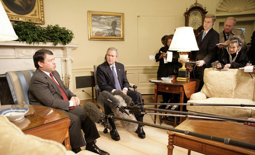 President George W. Bush listens as King Abdullah of Jordan makes remarks Wednesday, Feb. 8, 2006, during a photo opportunity in the Oval Office. The two leaders took the opportunity to urge an end to recent violence over caricatures of the Prophet Mohammed. White House photo by Eric Draper