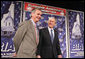 President George W. Bush stands with New Hampshire U.S. Senator Judd Gregg prior to addressing his remarks on the 2007 Budget and the Deficit Reduction Act of 2005, in a speech to the Business and Industry Association of New Hampshire, Wednesday, Feb. 8, 2006 in Manchester, N.H. White House photo by Paul Morse