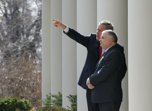 President George W. Bush shows Poland's President Lech Kaczynski points of interest around the White House from the Rose Garden steps outside the Oval Office, Thursday, Feb. 9, 2006 in Washington. White House photo by Eric Draper