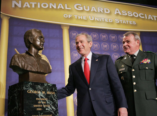 President George W. Bush admires a bust of himself presented in his honor Thursday, Feb. 9, 2006 at the National Guard Memorial Building in Washington, where President Bush talked about the global war on terror. White House photo by Paul Morse