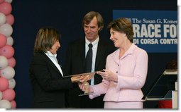 Mrs. Laura Bush presents the first Komen Italia Award, Thursday, Feb. 9, 2006 to Mrs. Marisa Giannini, a cancer survivor and the director of the Philatelic division of the Italian Postal Service, for her volunteer services with Koman Italia of The Susan G. Komen Breast Cancer Foundation.  White House photo by Shealah Craighead