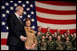 Laura Bush stands with U.S Ambassador to Italy Ron Spogli before speaking with troops during a visit to Aviano Air Base, in Aviano, Italy, Friday, Feb. 10, 2006. White House photo by Shealah Craighead