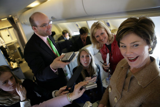 Laura Bush talks with members of the press aboard her plane en route to Turin, Italy, Friday, Feb. 10, 2006. White House photo by Shealah Craighead