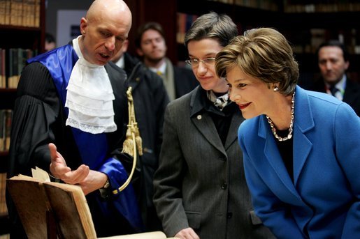 Laura Bush looks at an Ancient Thesis of Montichelli during a tour given by Paolo Novaria, Archives, left, at the University of Turin Saturday, Feb. 11, 2006, in Turin, Italy. White House photo by Shealah Craighead