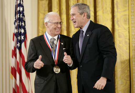 President George W. Bush presents a National Medal of Science, Monday, Feb. 13, 2006 to Dr.Norman E. Borlaug of Texas A&M University, during ceremonies in the East Room of the White House. Borlaug was honored for his work in creating disease resistant and high-yield wheat, providing a new quality food source for millions of people around the world. White House photo by Eric Draper