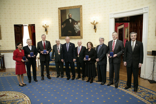 President George W. Bush and the U.S. Commerce Sec. Carlos Gutierrez, far-right, pose with the recipients of National Medal Technology, Monday, Feb. 13, of the White House. From left to right are Padmasree Warrior of Motorola, Nicholas M. Donofrio of IBM, Henry L. Nordhoff of Gen-Probe Inc., Roger L. Easton of RoBarCo, Ralph H. Baer of Manchester, N.H., Chrissie England and George Lucas of Industrial Light and Magic, and Mark. C. Pigott of PACCAR Inc. White House photo by Eric Draper