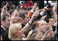 The crowd gives the 'Hook Em Horns' sign, Tuesday, Feb. 14, 2006 on the South Lawn of the White House, during ceremonies to honor the 2005 NCAA Football Champion University of Texas Longhorns. White House photo by Kimberlee Hewitt