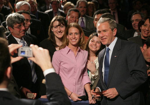 President George W. Bush takes a moment to pose for a picture with audience members Wednesday, Feb. 15, 2006 at Wendy's International, Inc. corporate headquarters in Dublin, Ohio, following his remarks on health care, and his commitment to help all Americans gain access to affordable, high-quality health care. White House photo by Paul Morse