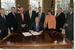 President George W. Bush is joined by legislators and the chairman of the Federal Deposit Insurance Corporation, Wednesday, Feb. 15, 2006 in the Oval Office, as he signs H.R. 4636- The Federal Deposit Insurance Reform Conforming Amendments Act of 2005. From left to right are U.S. Rep. Spencer Bachus, R-Ala., U.S. Sen. Tim Johnson, D-S.D., U.S. Sen Paul Sarbanes, D-Md., U.S. Sen. Richard Shelby, R-Ala., U.S. Rep. Mike Oxley, R-Ohio, U.S. Rep. Darlene Hooley, D-Ore., U.S. Sen. Mike Enzi, R-Wyo., and Martin Gruenberg, acting chairman of the Federal Deposit Insurance Corporation. White House photo by Kimberlee Hewitt