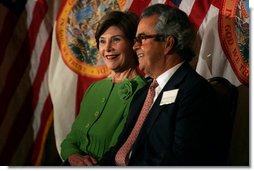 Laura Bush sits with Carlos del la Cruz, Event Host, during a Junior Ranger event Wednesday, Feb. 15, 2006, in Coral Gables, FL. The Junior Ranger programs introduces young people to America's national parks and historic sites, and is operating in 286 of the 388 National Parks across the country. White House photo by Shealah Craighead