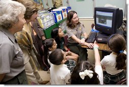Laura Bush and Fran Mainella look on as students of Stella Summer’s Gifted Science class work with Ranger Maria Beotegui Thursday, Feb. 16, 2006, to navigate through Web Rangers, the online version of Junior Rangers, during a visit to Banyan Elementary School in Miami, FL. The National Junior Ranger Programs promote knowledge of science, history, the environment and learning through fun. White House photo by Shealah Craighead