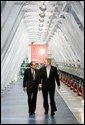 President George W. Bush and Dr. Subhendu Guha, President of United Solar Ovonic LLC, tour the company's solar cell production area in Auburn Hills, Michigan, Monday, Feb. 20, 2006. White House photo by Eric Draper