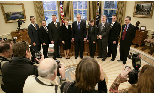 President George W. Bush and the crew members of the Space Shuttle Discovery (STS-114) pose for news photographers in the Oval Office at the White House, Wednesday, Feb. 22, 2006. The STS-114 crew was the first U.S. Space Shuttle flight, July 26, 2005, since the February 2003 loss of the Space Shuttle Columbia. White House photo by Eric Draper