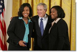 President George W. Bush congratulates Carrietha "Katie" Ball and her sister, Karl'Nequa Ball of Jackson, Miss., after awarding them the President's Volunteer Service Awards during a White House celebration of African American History Month. White House photo by Paul Morse