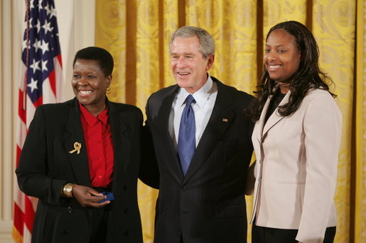 President George W. Bush is joined by Joan Thomas of Smyrna, Ga., left, and Erica Turner, who was mentored by Thomas, after Thomas received the President's Volunteer Service Award at a White House celebration of African American History Month. White House photo by Paul Morse