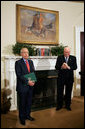 Vice President Dick Cheney applauds Lieutenant Bernard W. Bail, recipient of the Distinguished Service Cross, in the Roosevelt Room at the White House, Friday, February 24, 2006. The Vice President awarded the Distinguished Service Cross to Lt. Bail for his extraordinary acts of heroism during World War II and commended Lt. Bail for being a "brave citizen who elevated service to country above self interest." White House photo by David Bohrer
