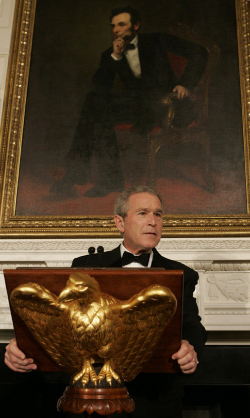 President George W. Bush, standing beneath a painting of President Abraham Lincoln, Sunday evening, Feb. 26, 2006 in the State Dining Room of the White House, welcomes guests to the State Dinner for the nation's governors. White House photo by Kimberlee Hewitt