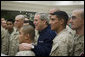 President George W. Bush poses for photos with U.S. Marines headed to Iraq, during a stopover Tuesday evening, Feb. 28, 2006 at Shannon, Ireland's international airport terminal. President George W. Bush meets with U.S. Marines headed to Iraq, during a stopover Tuesday evening, Feb. 28, 2006 at Shannon, Ireland's international airport terminal. President Bush visited with the Marines as part of his five-day visit to India and Pakistan. White House photo by Paul Morse