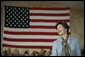Mrs.Laura Bush appears before an audience of U.S. and Coalition troops, Wednesday, March 1, 2006, during a visit to Bagram Air Base in Afghanistan, where President George W. Bush thanked the troops for their service in defense of freedom. White House photo by Eric Draper