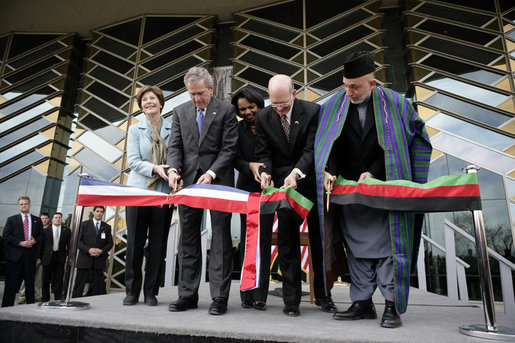 President George W. Bush and Afghanistan President Hamid Karzai, right, cut the ceremonial ribbon, Wednesday, March 1, 2006, to dedicate the new U.S. Embassy Building in Kabul, Afghanistan. President Bush is joined by Mrs. Laura Bush; U.S. Secretary of State Condoleezza Rice and U.S. Ambassador to Afghanistan Ronald E. Neumann. White House photo by Eric Draper