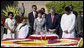 President George W. Bush and Laura Bush are joined by Rajnish Kumar, right, Secretary of the Rajghat Samadhi Committee, and Dr. Nirmila Deshpande, co-Chair of the Rajghat Gandhi Samadhi committee, for a moment of silence at the Mahatma Gandhi Memorial in Rajghat, India. White House photo by Eric Draper