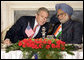 President George W. Bush leans in to speak with India's Prime Minister Manmohan Singh during meetings Thursday, March 2, 2006, in New Delhi. White House photo by Eric Draper