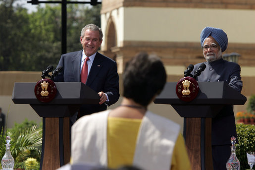 President George W. Bush smiles as he responds to a question Thursday, March 2, 2006, during a press availability with India's Prime Minister Manmohan Singh in the Mughal Garden at the Hyderabad House in New Delhi. White House photo by Paul Morse