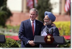 President George W. Bush and India's Prime Minister Manmohan Singh exchange handshakes Thursday, March 2, 2006, after their press availability at the Hyderabad House in New Delhi.  White House photo by Paul Morse
