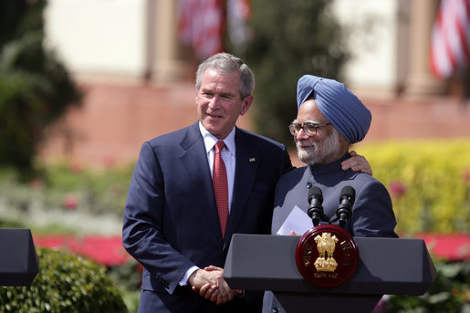 President George W. Bush and India's Prime Minister Manmohan Singh exchange handshakes Thursday, March 2, 2006, after their press availability at the Hyderabad House in New Delhi. White House photo by Paul Morse