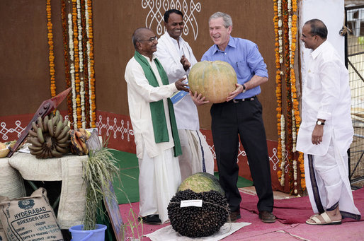 President George W. Bush has fun with some of the produce grown at the Acharya N.G. Ranga Agriculture University as he spends time there Friday, March 3, 2006, in Hyderabad, India. White House photo by Eric Draper