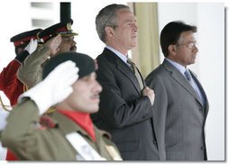 President George W. Bush and Pakistan President Pervez Musharraf stand together during President Bush's official welcome to Aiwan-e-Sadr in Islamabad, Pakistan, Saturday, March 4, 2006. White House photo by Eric Draper
